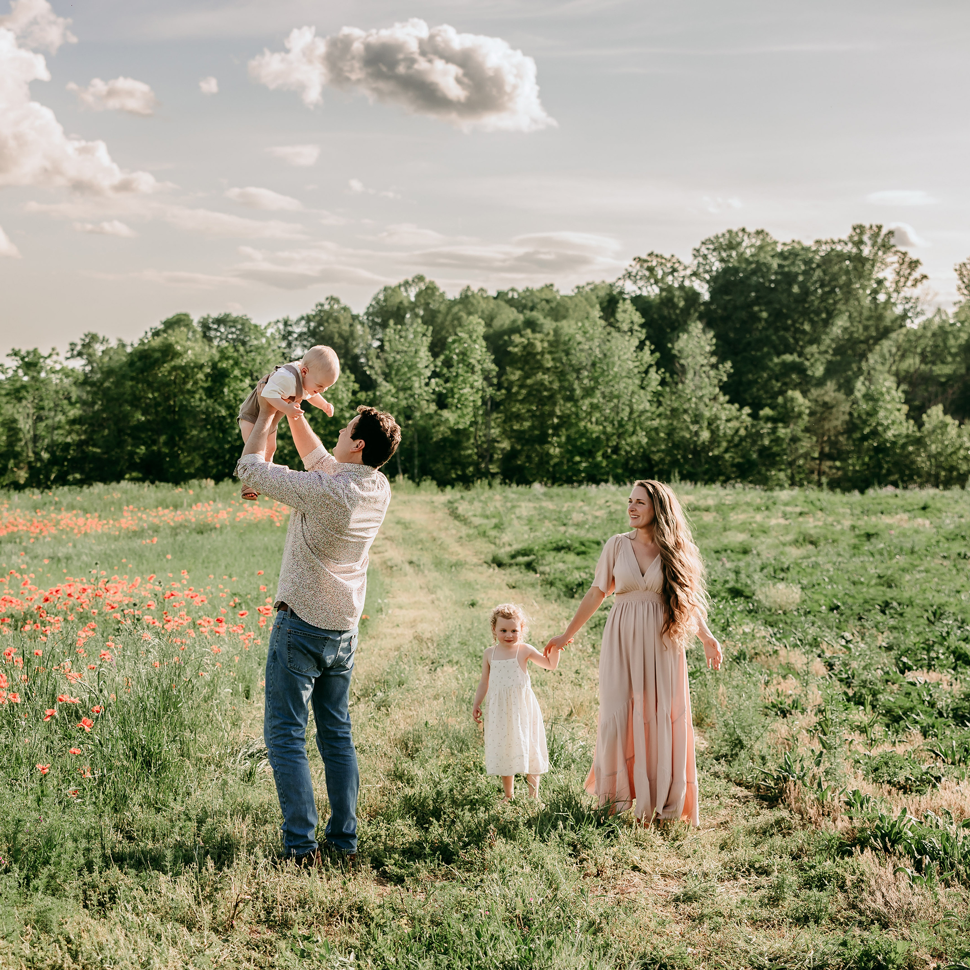 family of 4 in the flower field during winston salem family photoshoot
