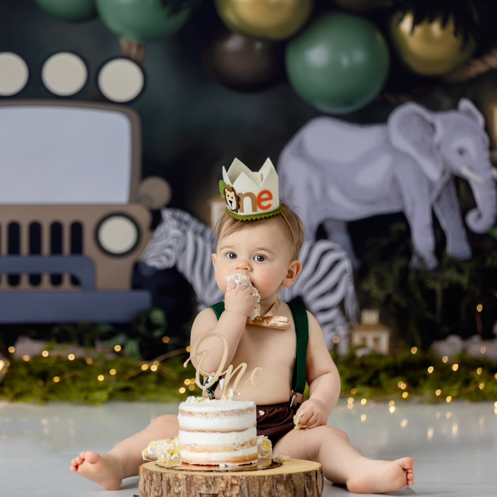 baby eating cake during first birthday cake smash photo session Greensboro photographer
