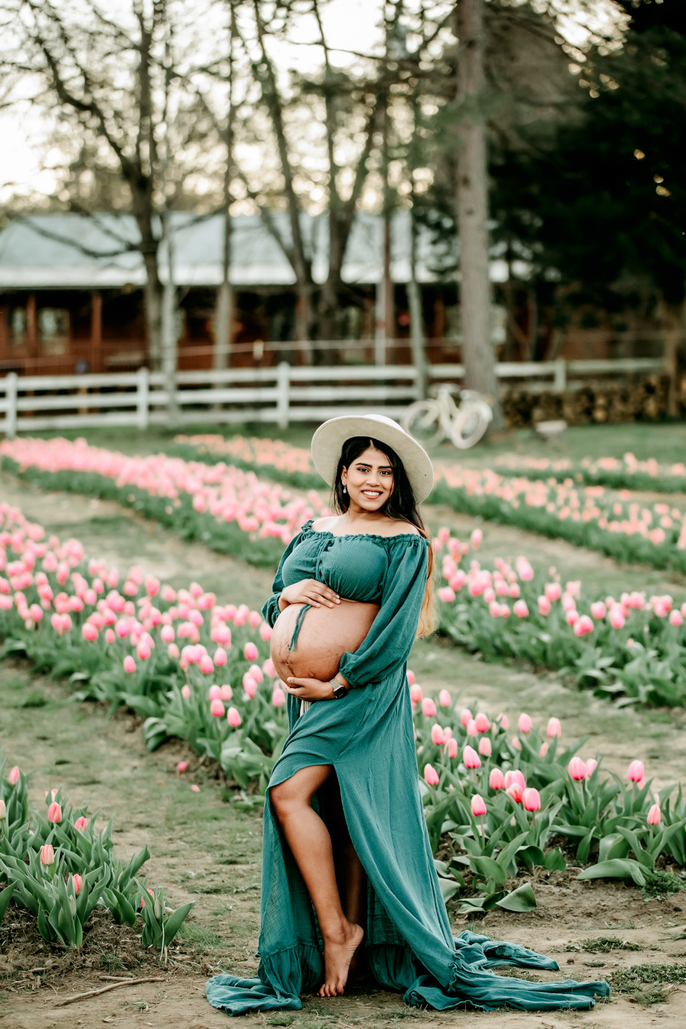 beatiful maternity woman in tulip field during maternity photoshoot Greensboro NC dewberry farm