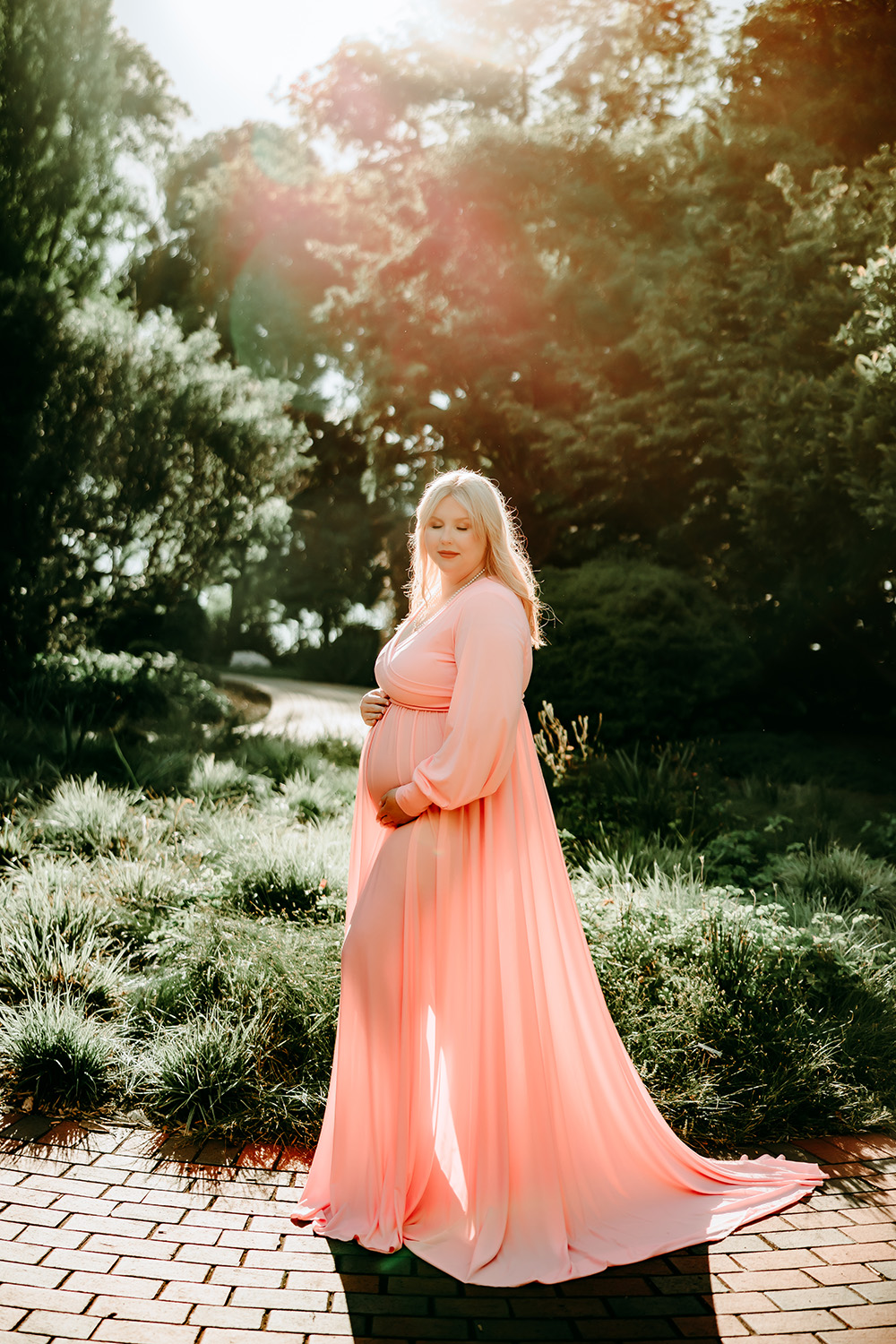 beautiful-pregnant-woman-in-pink-flowy-dress-in-Tanglewood-park-golden-hour-maternity-photoshoot-charlotte-photographer
