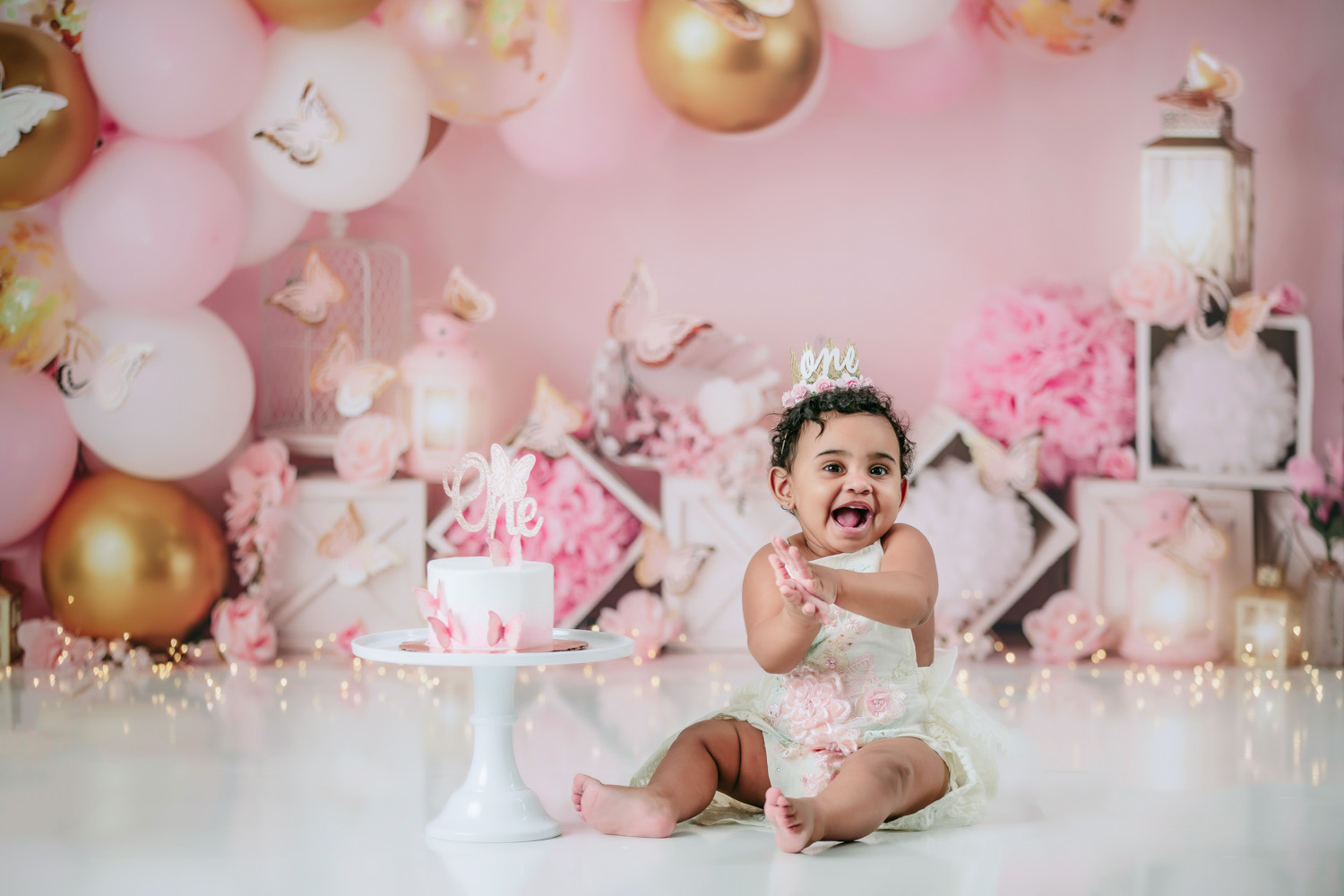 cute-happy-baby-girl-first-birthday-cake-smash-photoshoot-with-butterfly-theme-winston-salem-photography-studio
