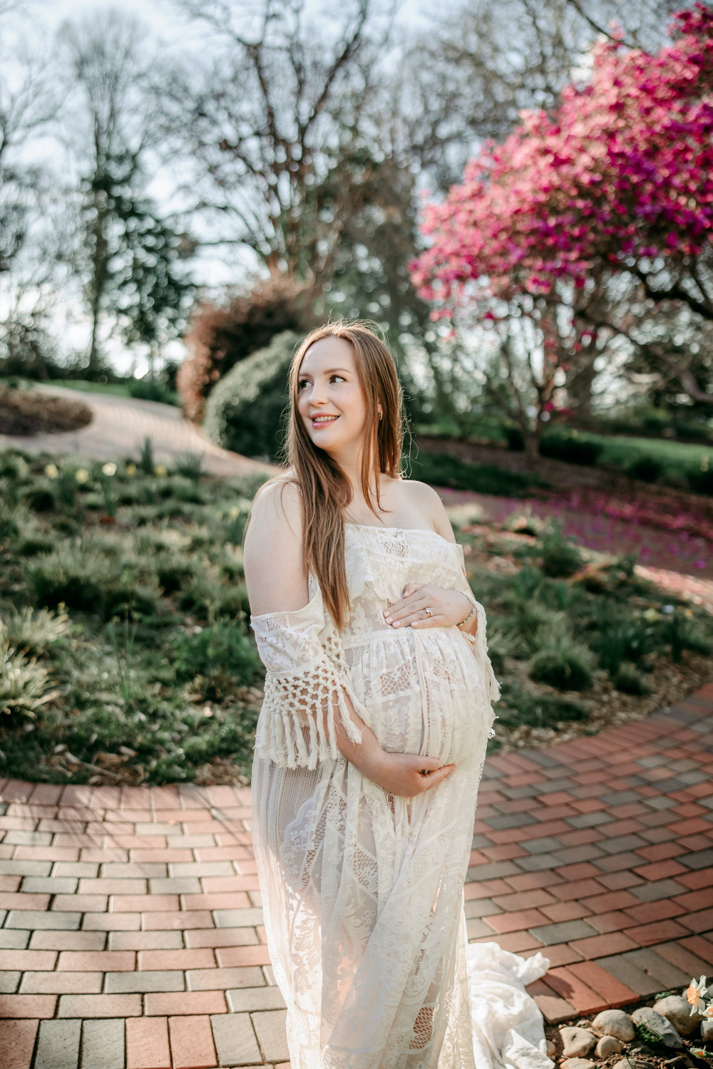 pregnant-mama-in-white-lace-dress-during-maternity-photo-session-in-winston-salem-tanglewood-park-photoshoot