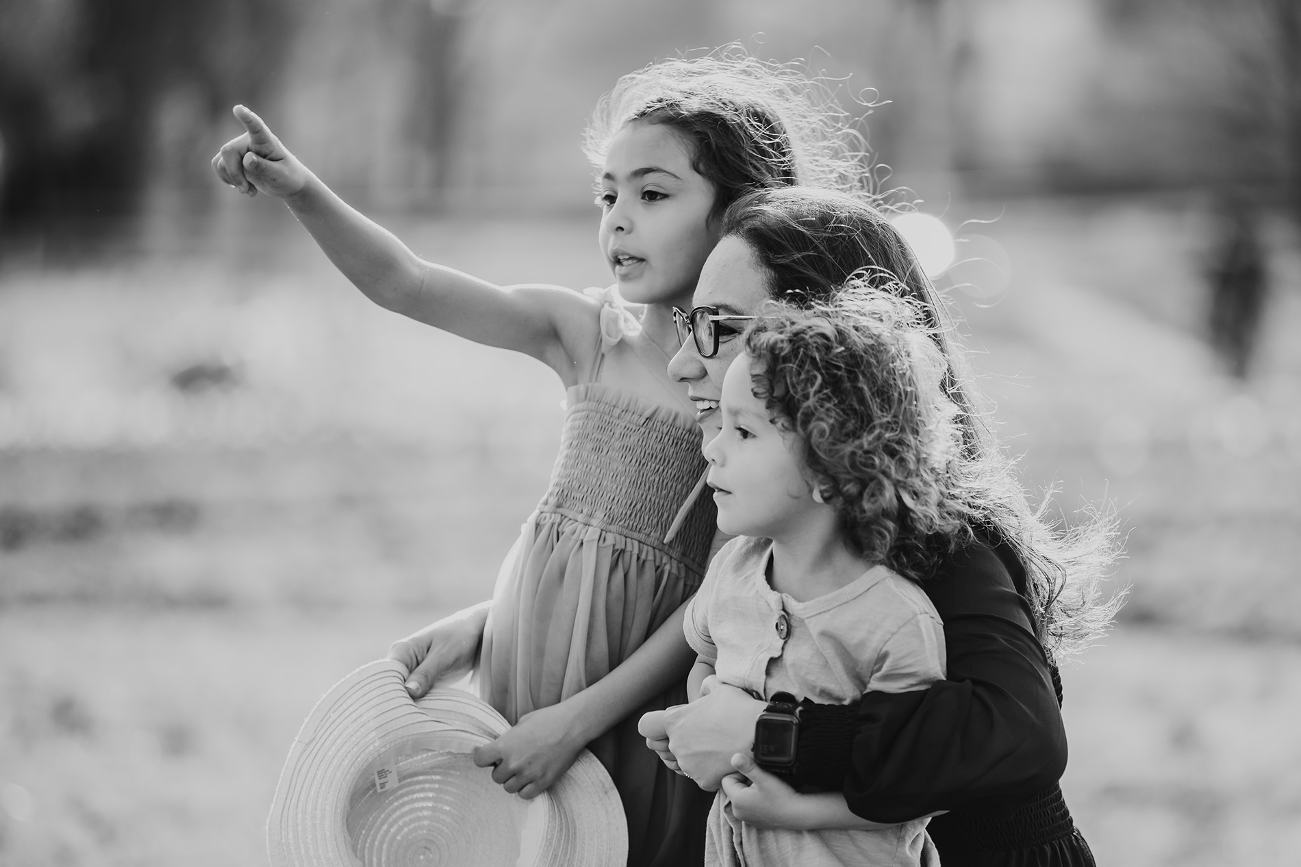 mommy-and-two-kids-looking-afar-by-the-lake-side-during-family-photoshoot-Winston-salem-family-photography