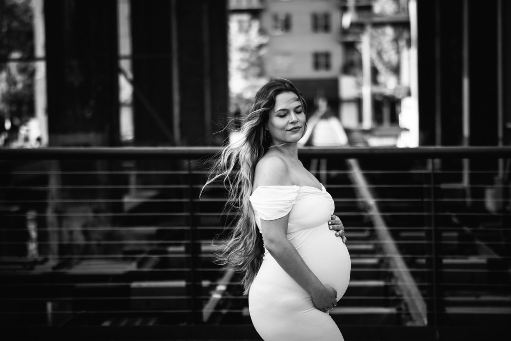 Elegant maternity mother in Black and white image in industrial background downtown winston-salem North Carolina maternity photo session