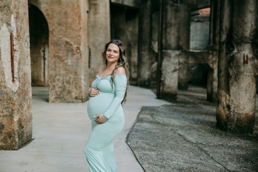 Elegant maternity mother in mint color fitted gown at Innovation quarter, Bailey park downtown winston-salem North Carolina maternity photo session with greensboro maternity photographer