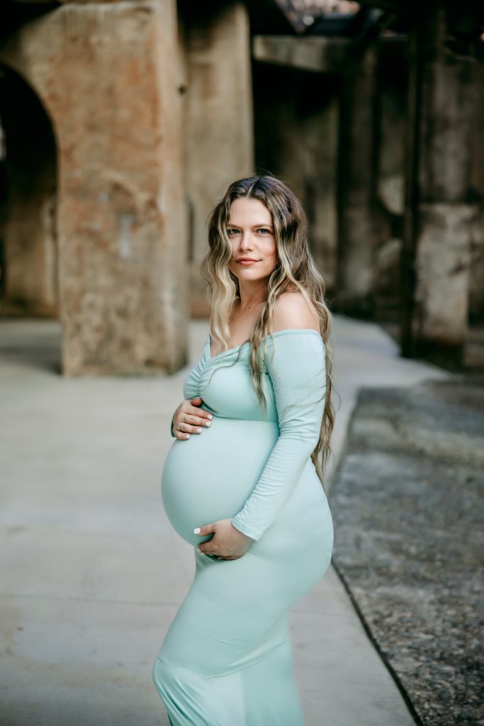Elegant maternity mother in mint color fitted gown at Innovation quarter, Bailey park downtown winston-salem North Carolina maternity photo session with greensboro maternity photographer