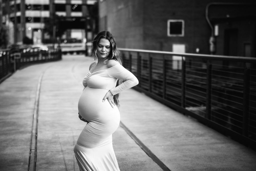 Black and white photo pof elegant maternity mother in a fitted gown at Innovation quarter, Bailey park downtown winston-salem North Carolina maternity photo session with greensboro maternity photographer