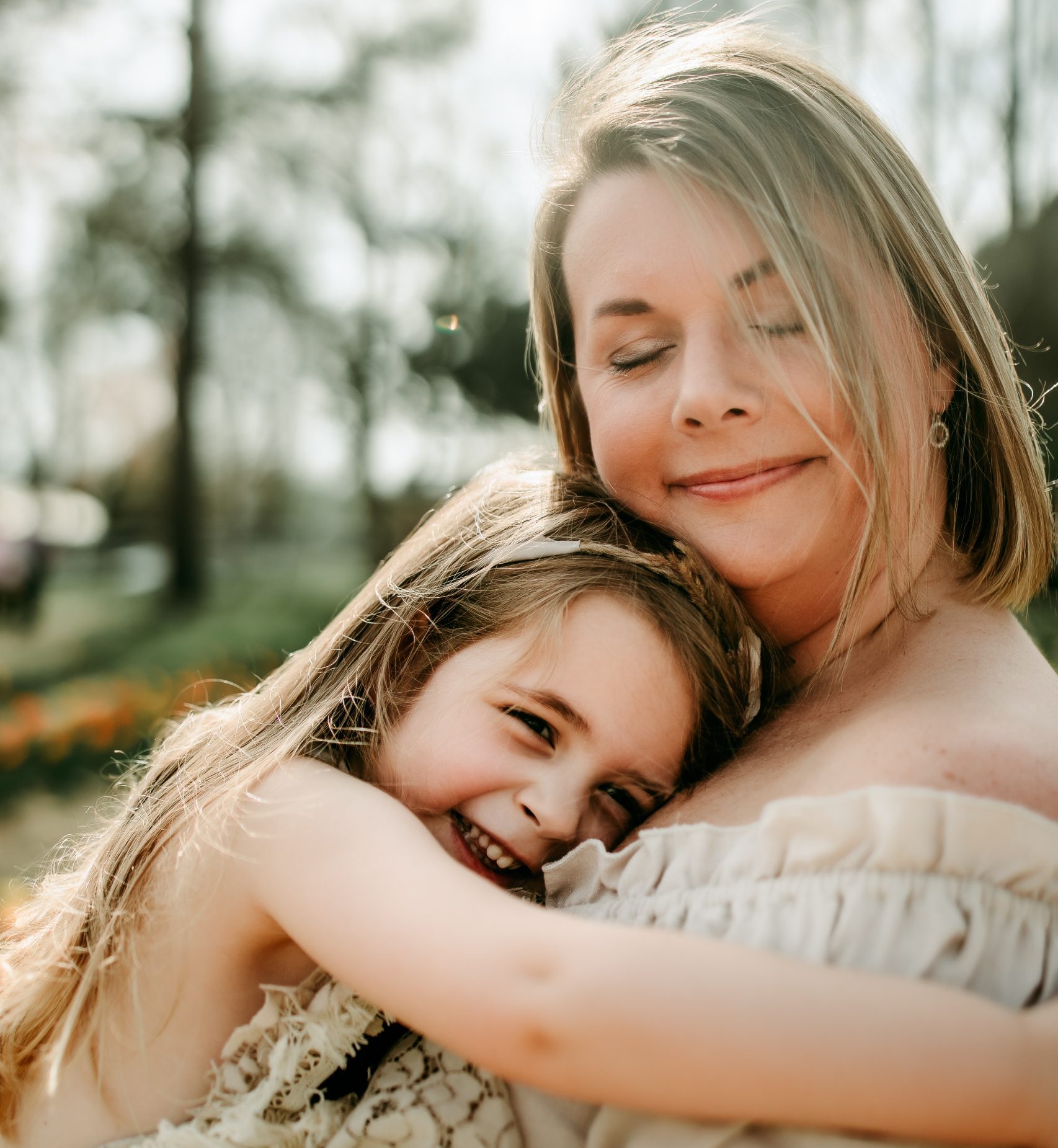 mommy hugging little girl during family photo session with winston salem photographer