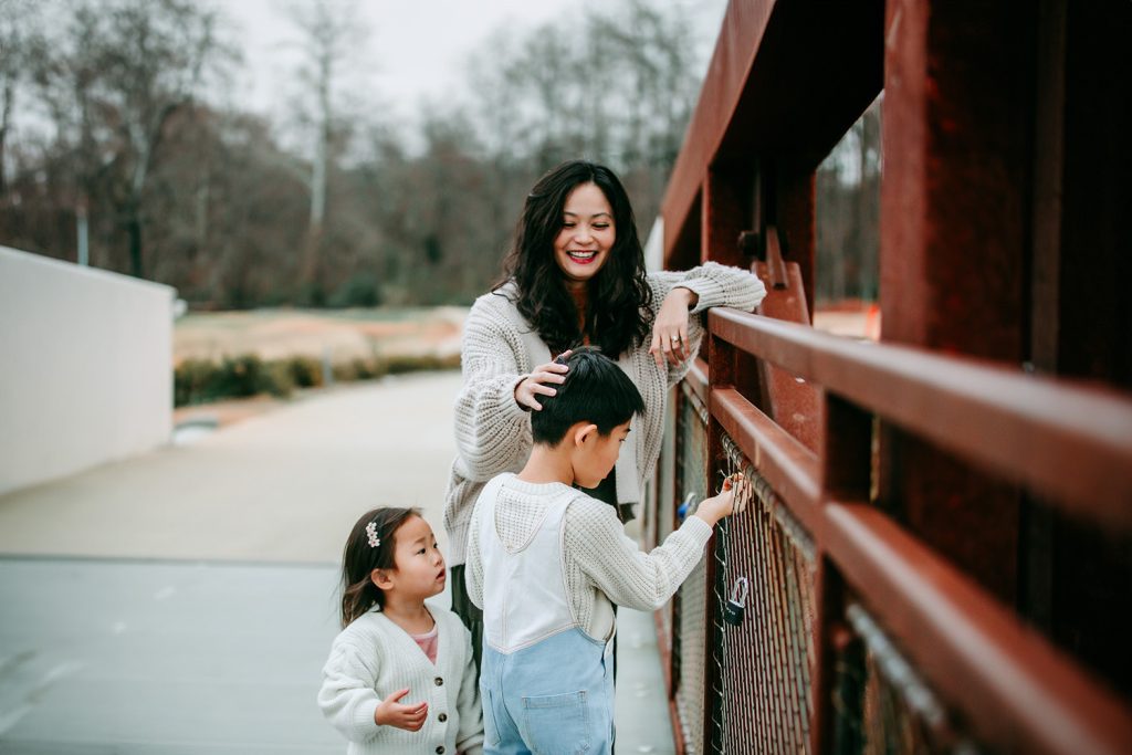 mom-with-daughter-and-son-on-the-iron-bridge-during-family-photoshoot-at-quarry-park-winston-salem-nc
