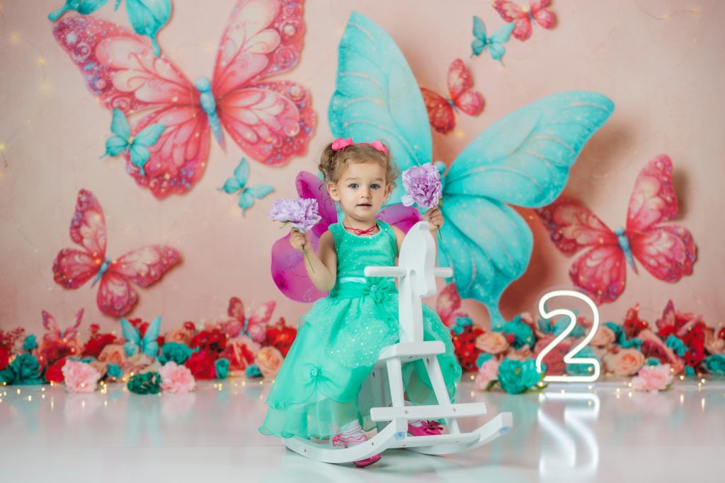 butterfly-Cake-smash-photoshoot-with-cute-baby-girl-in-teal-dress-and-fuchsia-wings-during-greensboro-photographer