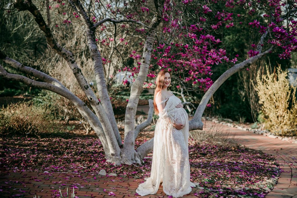 maternity-mother-in-white-lace-dress-during-golden-hour-maternity-photo-session-in-tanglewood-park-arboretum-winston-salem-NC