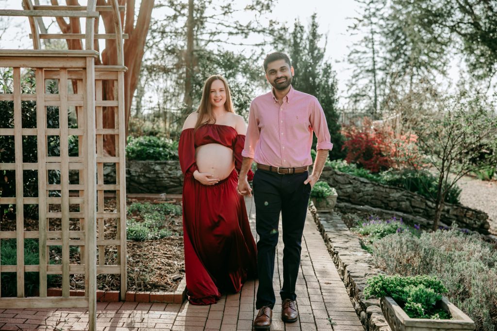 maternity-mother-walking-with-her-husband-during-maternity-photo-session-in-tanglewood-arboretum-Winston-Salem-NC
