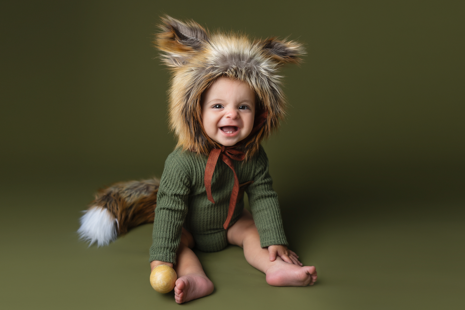 cute-baby-in-fox-bonnet-and-green-onesie-winston-salem-baby-photography-studio