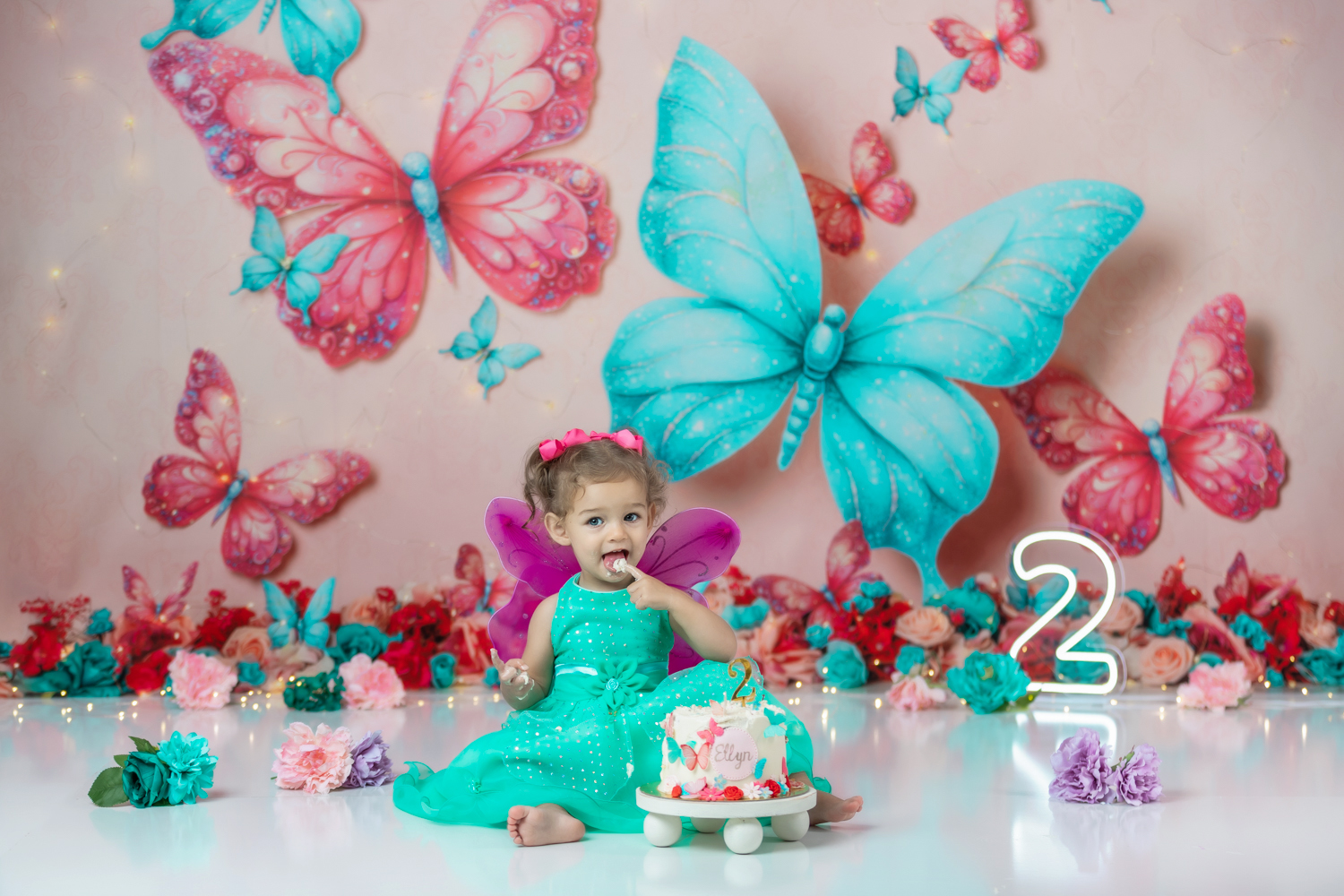 butterfly-Cake-smash-photoshoot-with-cute-baby-girl-in-teal-dress-and-fuchsia-wings-during-winston-salem-photographer