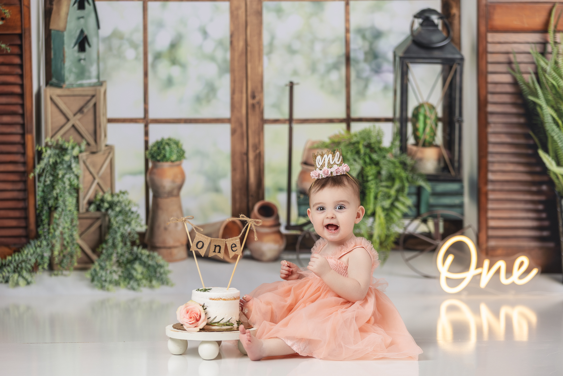 baby-girl-one-year-birthday-cake-smash-photos-with-boho-greenery-background-greensboro-baby-photo-studio