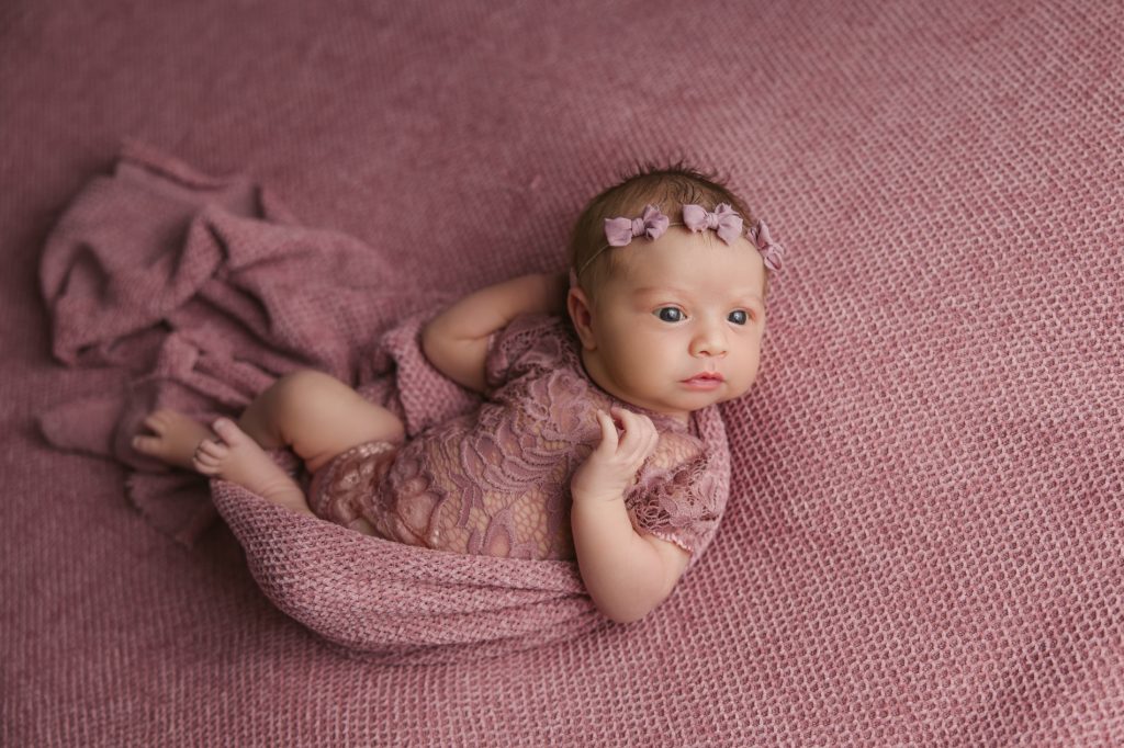 awake-newborn-baby-girl-photo-session-in pink background and pink outfit with-winston-salem-newborn-photographer