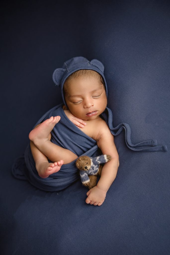 newborn-baby-boy-photoshoot in blue blanket and bear hat-greensboro-newborn-baby-photography-studio